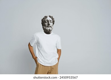 Minimal concept art, man with a statue head, Abstract modern collage. The man with the plaster head of a statue in a white t-shirt on a white  background - Powered by Shutterstock