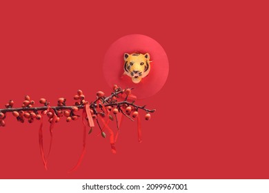 Minimal Concept Of Chinese Tiger Zodiac New Year Celebration. Fresh Branches With Red Berries And Red Thread Silk Lines Tight Up On It.Tiger Head In Red Circle Behind. Red Background.