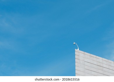 Minimal Corner Of The Building With Small Security Camera On Top. Concepts Of Security, Surveillance, Protection, Data