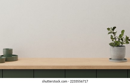 Minimal cozy counter mockup design for product presentation background. Branding in modern style with bright wood top green counter and warm white wall plant pot plates kitchenware. Kitchen interior. - Shutterstock ID 2233556717