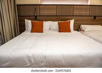 Minimal double bed and extra bed with white mattress in the bedroom. - Shutterstock ID 2169576201