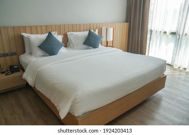 minimal double bed with white mattress in luxury hotel bedroom - Shutterstock ID 1924203413