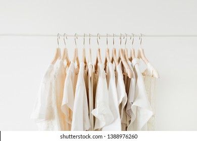 Premium Photo Minimal Aesthetic Fashion Clothes Concept Neutral Beige  Washed Linen Female Blouses Dresses And Tshirts On Hanger On White Background  Fashion Blog Website Social Media 