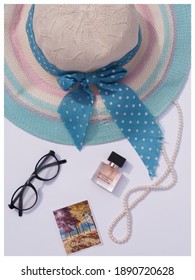 Minimal Fashion Concept With Straw Hat, Perfume, Glasses And 
Pearl Necklace. Flat Lay, Top View.
