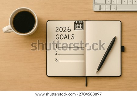 Minimal flat-lay of an open notebook labeled “2026 Goals” with pen and coffee on a clean desk. Perfect for themes of goal setting, planning, productivity, and New Year resolutions.