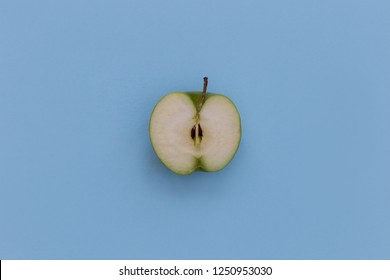 Minimal Food Green Apple Half Healthy Fruit On Blue Background