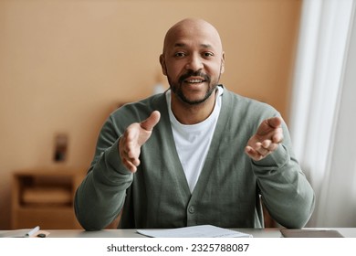 Minimal front view portrait of black man talking animatedly at camera, copy space