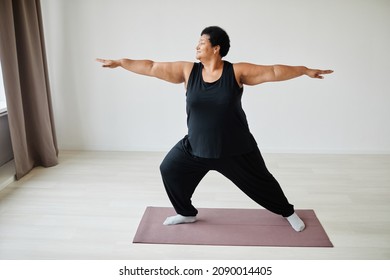 Minimal Full Length Portrait Of Active Senior Woman Doing Yoga Indoors And Smiling, Copy Space