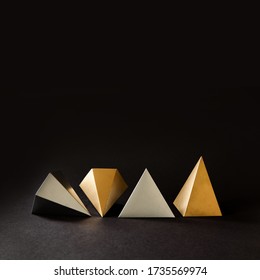 Minimal geometry still life composition. Platonic solids figures geometry. Abstract gold and silver color geometrical figures. Three-dimensional pyramid objects on black background. - Shutterstock ID 1735569974