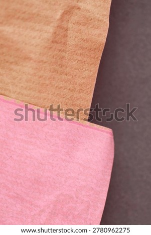 Minimal layered paper composition featuring warm brown and soft pink handmade paper textures. Modern abstract background ideal for branding and contemporary design.