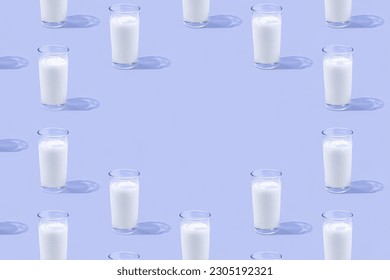 Minimal natural beverages pattern with glasses of milk. Pastel purple background with copy space, shadows and sun reflections. Food and drink texture concept. Dairy source of calcium and vitamins. - Powered by Shutterstock