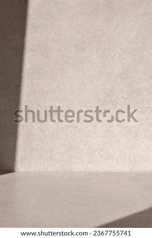 Minimal neutral beige empty concrete table or floor surface and wall background with natural abstract light shadow. Interior brand design template for product presentation placement.