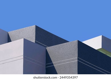 Minimal Office Building in Geometric Modern style with Light and Shadow on Gray and White Rough Concrete Wall Texture Surface against Blue Sky background, Exterior architecture Design - Powered by Shutterstock