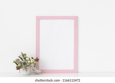 Minimal Pink Portrait Frame Mockup With Dried Field Wild Flowers In Pot On White Wall Background. Empty Frame, Poster Mock Up For Presentation Design. Template Frame For Text, Lettering, Modern Art.