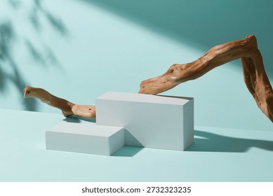 Minimal scene with a white rectangular podium and curved wooden branch on pastel blue background, designed for clean product placement and modern branding layouts