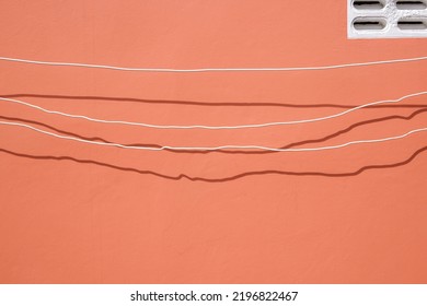 Minimal Simplicity Background Of Electrical Cables Are Temporarily Installed On Brown Wall For Outside Home Improvement Work.