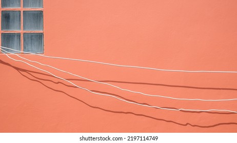 Minimal Simplicity Background Of Electrical Cables Are Temporarily Installed On Brown Wall For Outside Home Improvement Work.