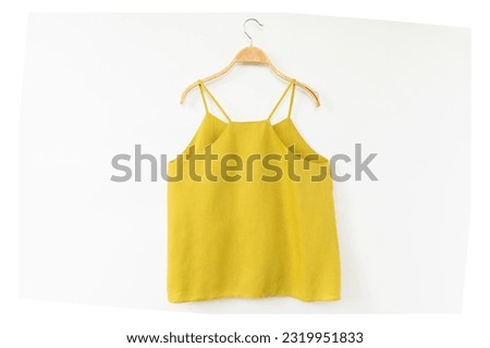 Minimal style.Yellow woman clothes is clothes hanger on white background.close up