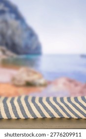 Minimal summer composition featuring clean sandy beach with empty copy space for product placement. In the background, a rocky coastline meets the sea under a bright blue sky, creating a natural and scenic atmosphere. Ideal for advertising, travel promotions, and summer lifestyle concepts.