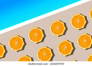 Minimal summer vacation concept. Areal view of sun umbrellas made of fresh orange halfs on the sandy beach near the blue sea. - Shutterstock ID 2234299707