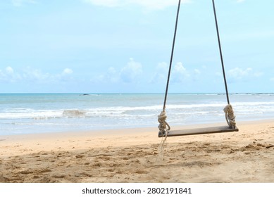 Minimal tropical composition featuring a swing positioned beside a wide area of clean negative space. Excellent background for tourism campaigns, resort promotions, lifestyle brands and inspirational marketing materials.