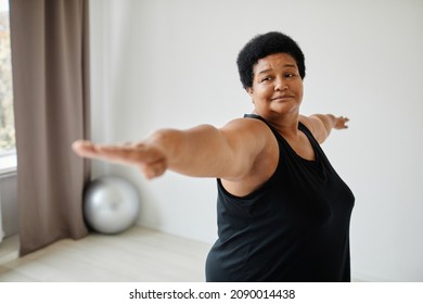 Minimal Waist Up Portrait Of Active Senior Woman Working Out Indoors And Stretching