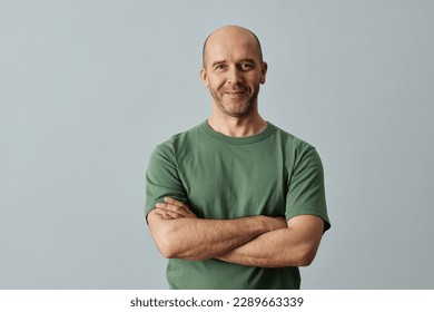 Minimal waist up portrait of mature bald man smiling at camera while standing confidently with arms crossed, copy space - Shutterstock ID 2289663339
