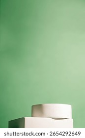 Minimal white cylindrical and rectangular podiums are placed against a soft green background. Perfect for showcasing skincare, cosmetics, eco-friendly products, or modern branding mockups