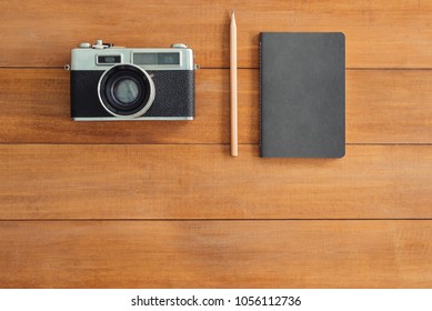 Minimal work space - Creative flat lay photo of workspace desk. Office desk wooden table background with mock up notebooks and retro camera. Top view with copy space, flat lay photography