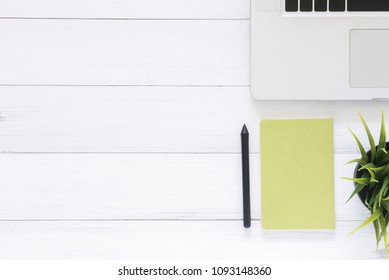 Minimal work space - Creative flat lay photo of workspace desk. Top view office desk with laptop, mock up notebooks and plant on white wooden background. Top view with copy space, flat lay photography