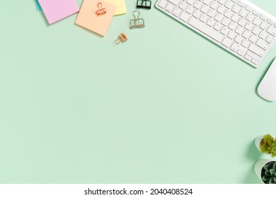 Minimal Work Space - Creative Flat Lay Photo Of Workspace Desk. Top View Office Desk With Keyboard, Mouse And Book On Pastel Green Color Background. Top View With Copy Space, Flat Lay Photography.