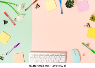 Minimal work space - Creative flat lay photo of workspace desk. Top view office desk with keyboard, mouse and adhesive note on pastel green pink color background. Top view with copy space photography.