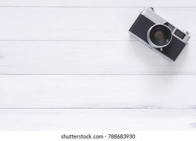 Minimal Work Space - Creative Flat Lay Photo Of Workspace Desk. Office Desk Wooden Table With Old Camera. Top View With Copy Space. Top View Of Old Camera Over Wooden Table. Retro Vintage Filter.