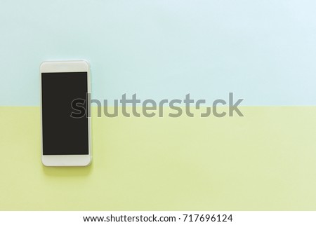 Minimal work space - Creative flat lay photo of workspace desk with mobile phone with blank screen on copy space green and blue pastel background. Top view mock up , flat lay photography.