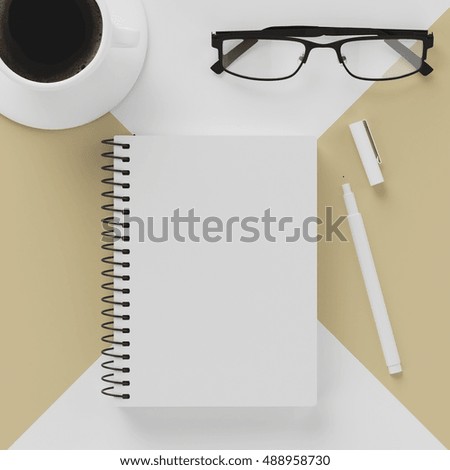 Minimal work space : notebook , white pencil , cup of coffee , glasses on pastel yellow contrast white background. Top view , flat lay
