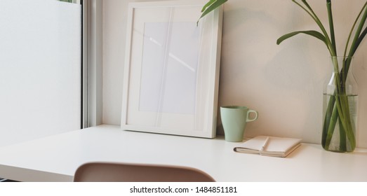Minimal workplace with mock up frame and copy space with white table 