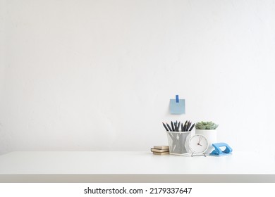 Minimal Workspace. Desk With Office Supplies White Wall And Empty Product Space.
