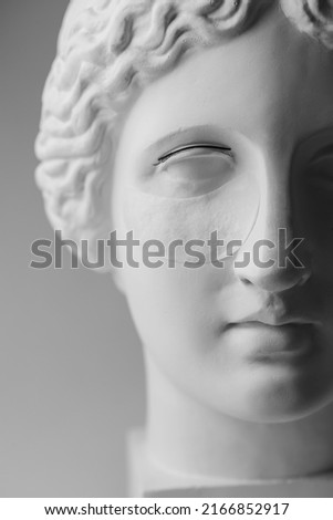 Minimalism beauty fashion background concept of eyelash extension procedure on antique sculpture.