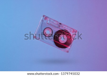 Minimalism retro style concept. 80s. Audio cassette in neon red blue light. Retro wave