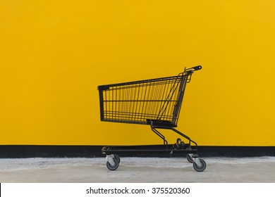 Minimalism style, Shopping cart black color and yellow wall at supermarket. - Powered by Shutterstock