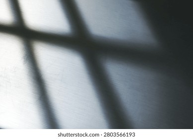 Minimalist abstract composition of light and shadow on brushed steel surface