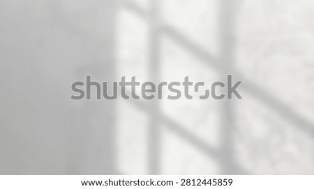 A minimalist abstract pattern created by window shadows cast on a plain white wall, evoking a sense of calm and simplicity.