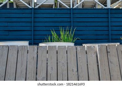 Minimalist Aesthetics. Minimal Detail, Wood Fence, White Barrel And Blue Wood Wall Background. Naval Architecture.