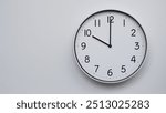 Minimalist Analog Wall Clock with White Face and Simple Black Hands Showing 22.00, 10.00. Ideal for Time Management and Modern Decor Concepts