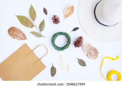 Minimalist Autumn Concept. Paper Bag, White Hat, Ribbon Rope, Dried Leaves, Pine Flowers, Krans Wreath Isolated On White Paper Background. Minimalist Christmas Concept
 - Powered by Shutterstock