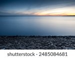 minimalist background with rocky shore above the water
