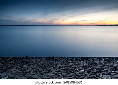 minimalist background with rocky shore above the water - Powered by Shutterstock