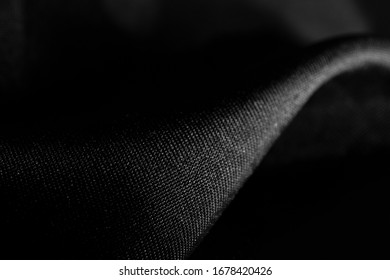 Minimalist black and white close up of a satin fabric