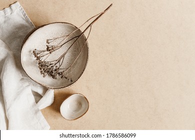 Minimalist Ceramic Bowl With Dry Plant Over Kraft Paper Background. Copy Space, Flat Lay.