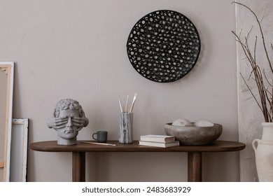 Minimalist composition of artist living room interior with wooden consola, ornament on wall, books, stylish sculpture, vase with branch, brown wall and personal accessories. Home decor. Template. - Powered by Shutterstock